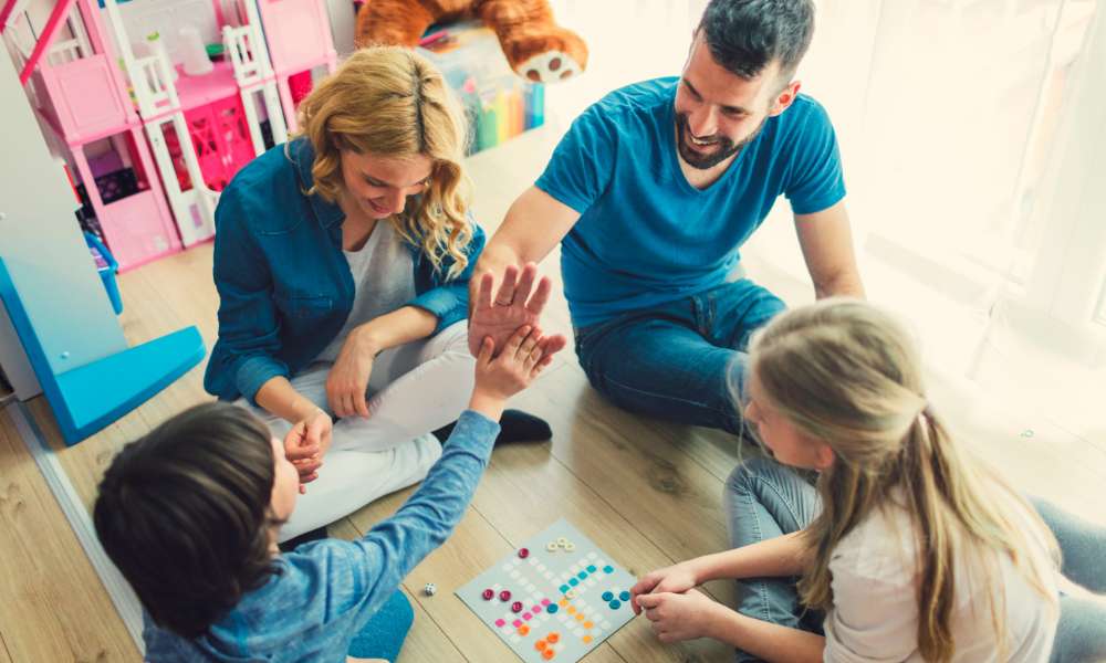 family playing a boardgame during game night/trivia night