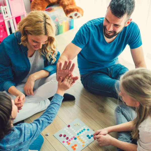 family playing a boardgame during game night/trivia night